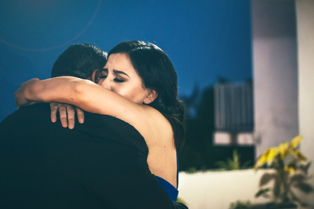 couple reconciling hug